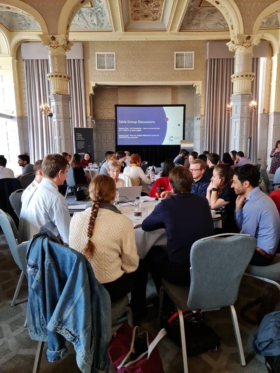 Photo of delegates around tables at the JING meeting